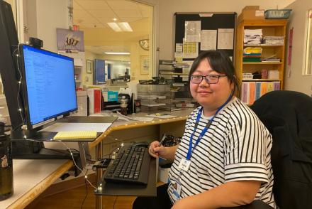 Jingjing sits at a desk in her hospital unit